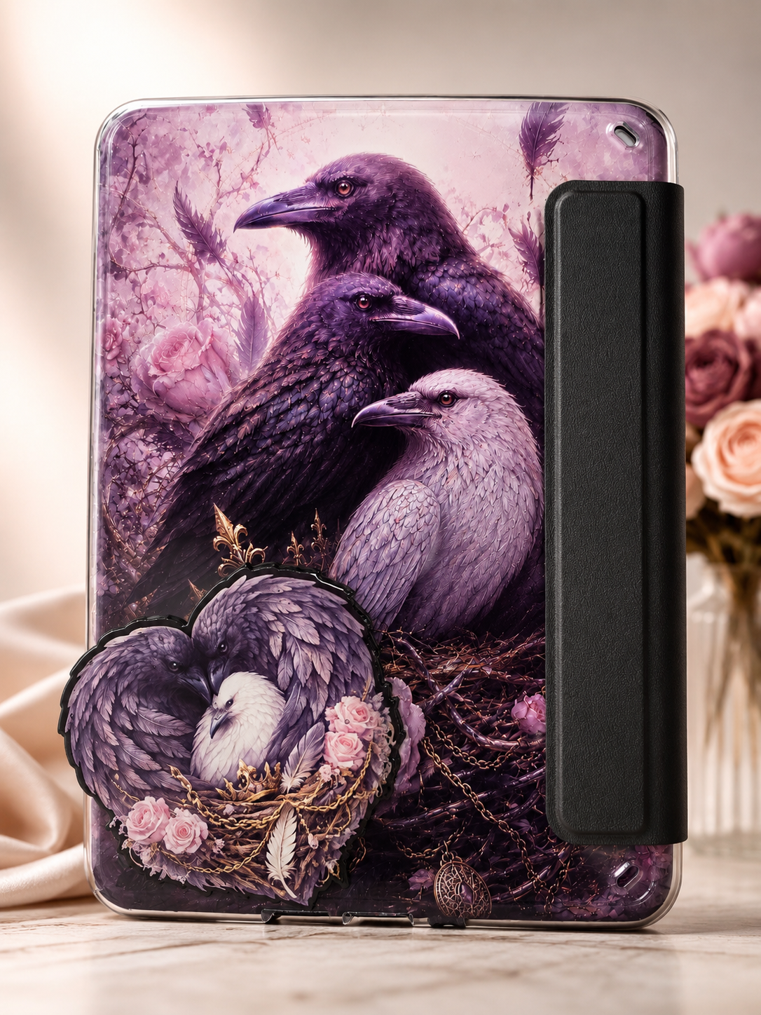 Raven-inspired dark romantasy Kindle accessory bundle featuring a purple gothic fantasy Kindle insert, matching magnetic reading grip, and coordinating beaded pen with feather and floral details.