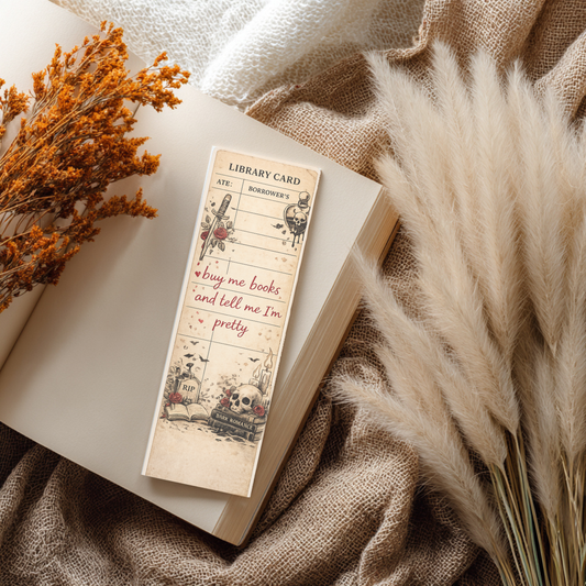Vintage dark romance library card bookmark with skulls, roses, and gothic bookish artwork on an open book