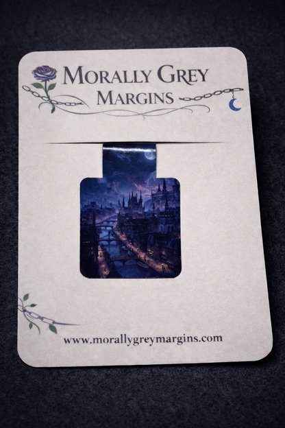Bookish magnetic bookmark featuring a glowing fantasy city at night with bridges and lantern lights, handmade page marker by Morally Grey Margins