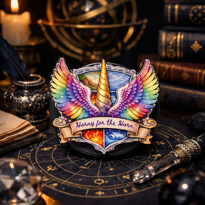 Colorful unicorn emblem with rainbow wings on a dark background with books and a candle.