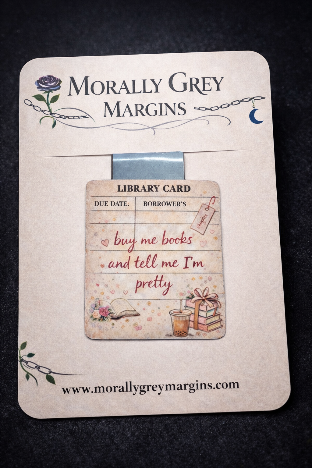 Library card style magnetic bookmark with the phrase “buy me books and tell me I’m pretty,” featuring cozy bookish illustrations.