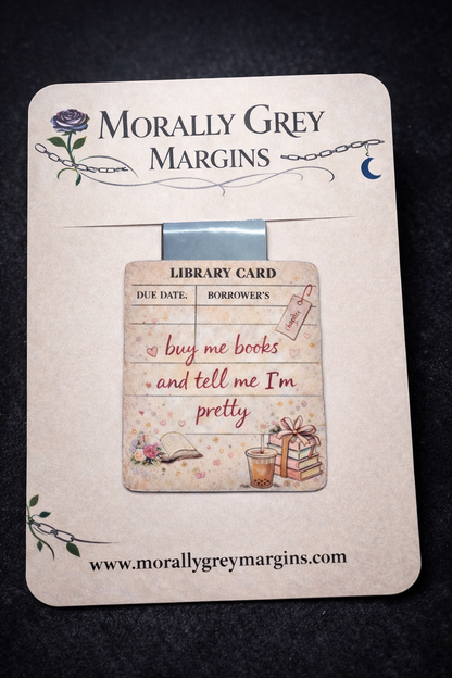 Library card style magnetic bookmark with the phrase “buy me books and tell me I’m pretty,” featuring cozy bookish illustrations.