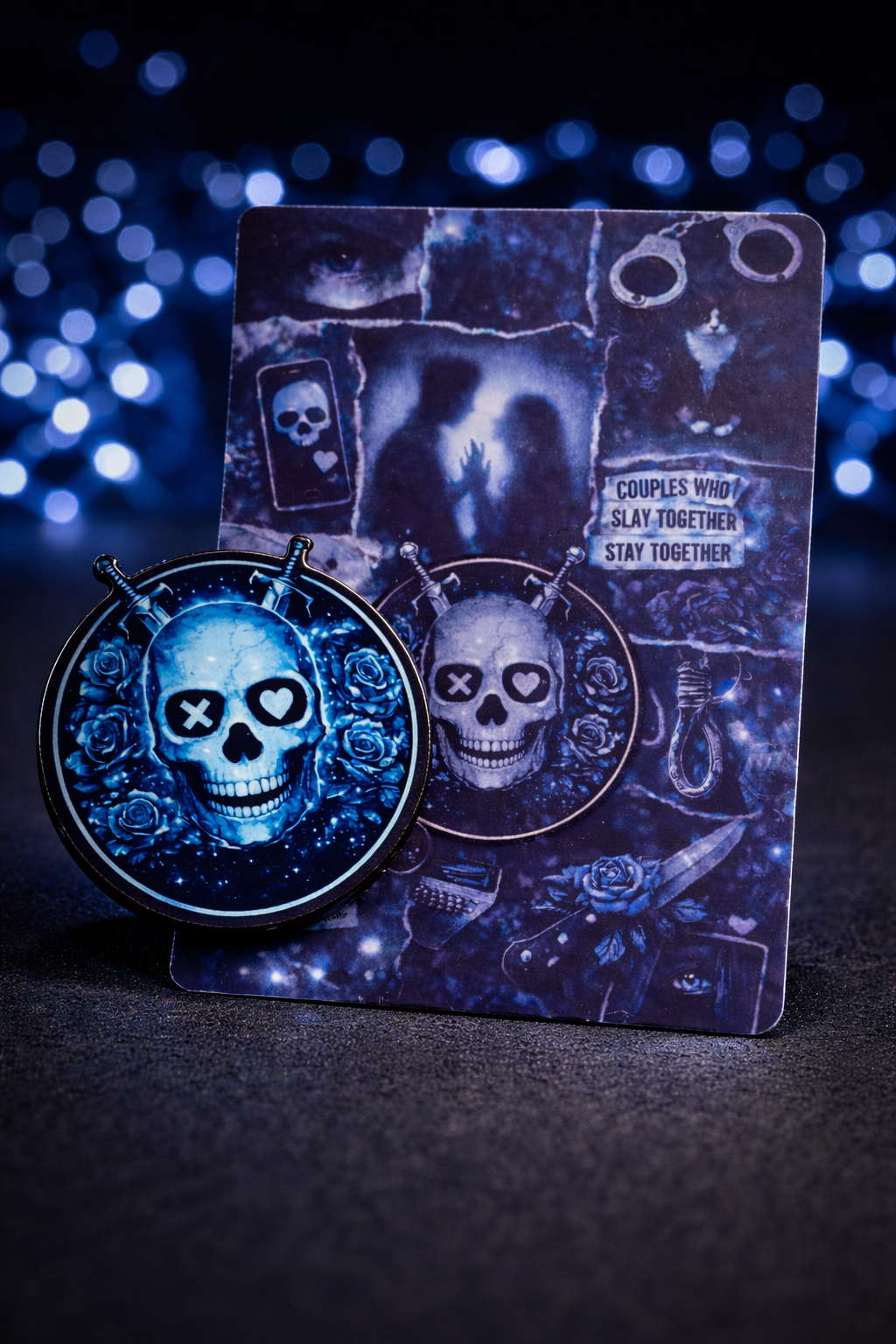 Blue skull pendant with a dark, textured card featuring similar designs and text.