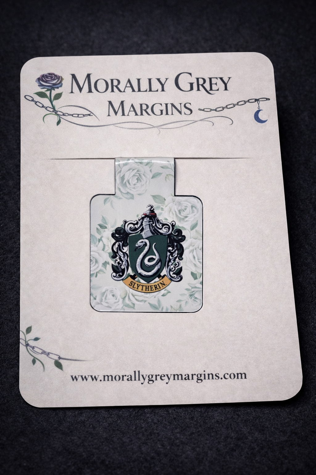 Bookish magnetic bookmark featuring a green serpent crest with floral background, handmade dark academia page marker by Morally Grey Margins