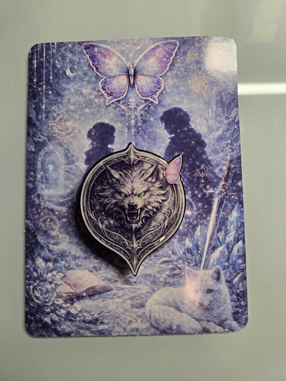 Matching fantasy romance MagSafe grip featuring detailed silver wolf design with glowing green eyes